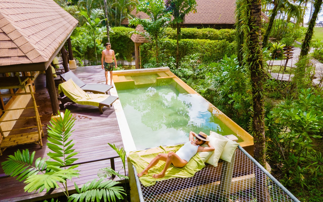 A green pool outside of a villa